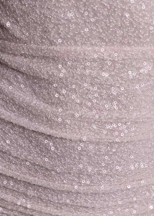 Women’s baby pink sequin cross-neck mini dress with keyhole cut-out at the bust, draped waist detail, and bodycon fit. Perfect sparkly party or evening dress. Model is 5ft2 wearing size XS UK 6.