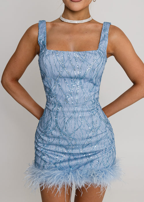 Women's blue glitter mini dress with blue feather trim, square neckline and bodycon fit. Model is 5ft2' and wears a size XS 6.