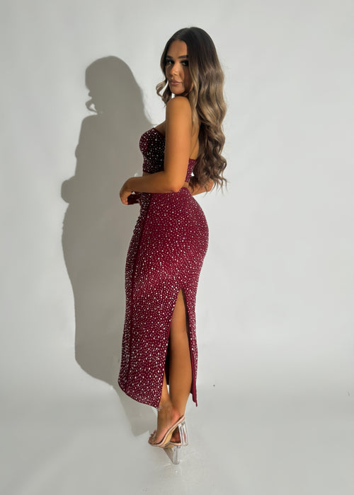 Women's embellished burgundy two-piece set. Bandeau crop top fully embellished in hot fix and matching burgundy maxi skirt with thigh high slit.