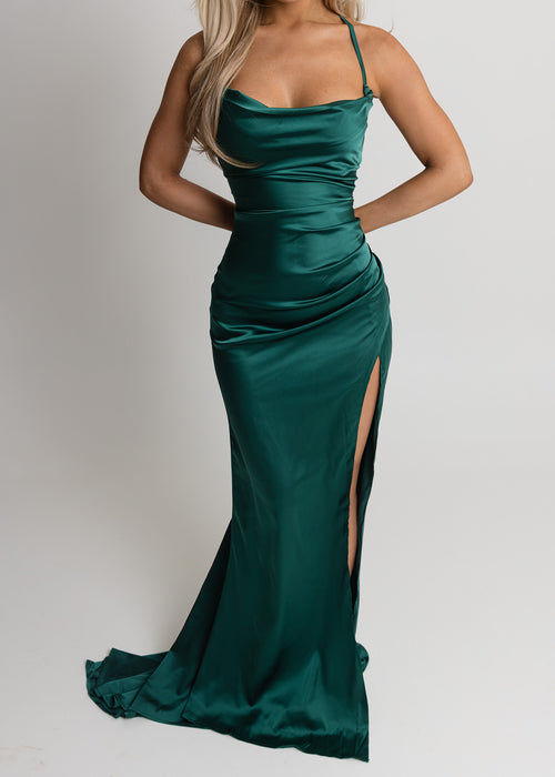 Women's emerald green satin gown with spaghetti straps, thigh slit and ruched detailing for a flattering, figure hugging fit
