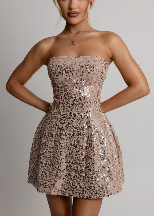 Women's gold sequin mini dress with strapless fit and a-line style. Fully embellished with rose gold sequins. Model is 5ft3' and wears a size XS 6.
