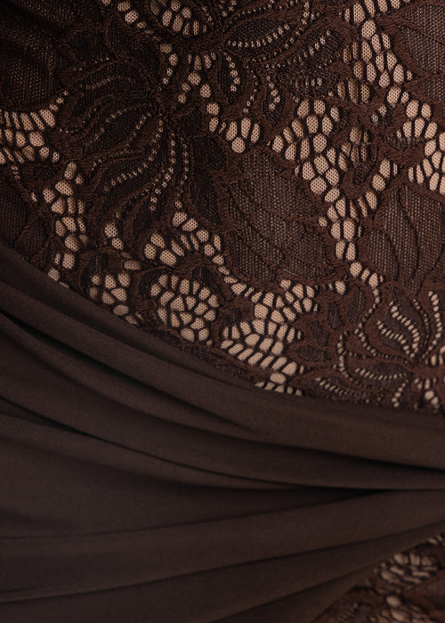 Close up swatch of brown lace mini dress with nude underlay and brown jersey wrap detail.