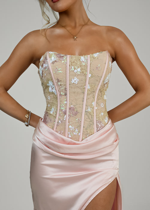 Women's corset pink prom gown with embellished corset and satin skirt with thigh slit. Strapless design and figure hugging fit.