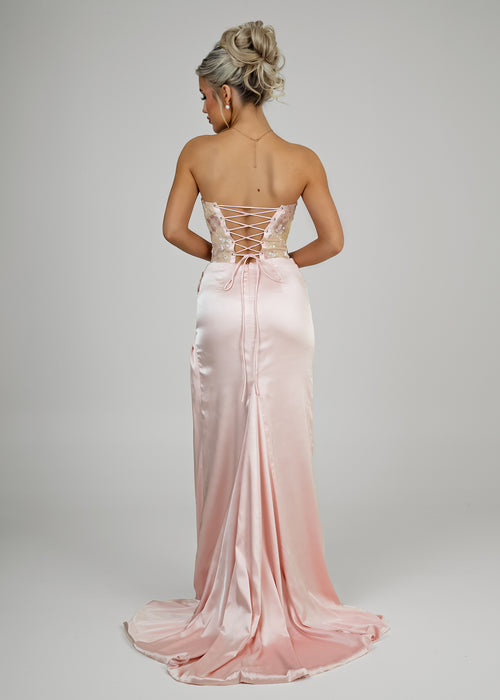 Women's corset pink prom gown with embellished corset and satin skirt with thigh slit. Strapless design and figure hugging fit.