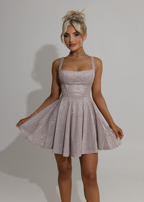 Women's pink glittery skater mini dress with square neckline and pleated skater style skirt. Model is 5ft2' and wears a size XS 6.