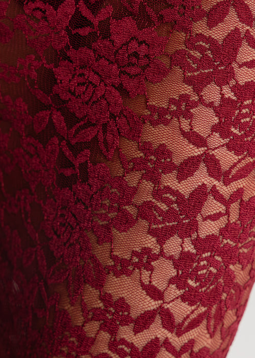 Close up detail of sheer burgundy lace fabric 