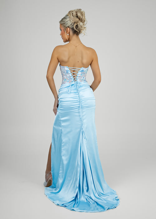 Back image of women's prom gown with tie up corset bodice and zip up back with elegant flowing train.