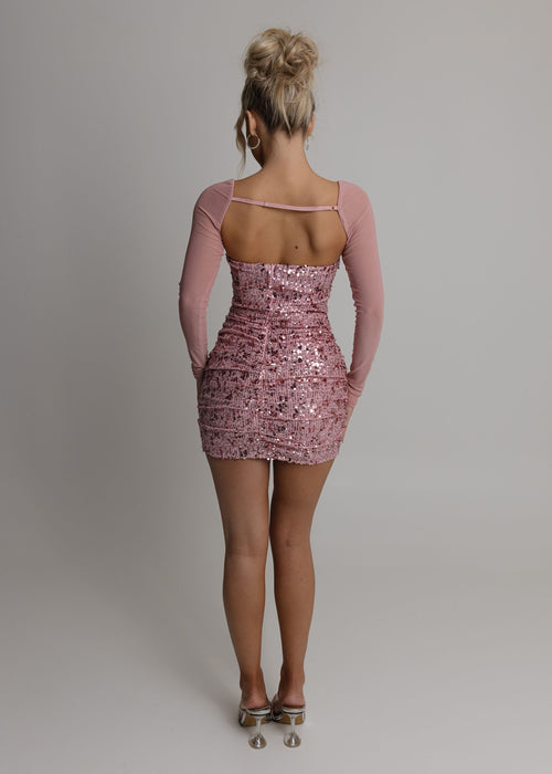 Women's pink sequin mini dress with detachable sleeves so dress can be worn two different ways, with sleeves or strapless. Fully embellished with pink sparkly sequins and mesh pink sleeves.  Model is 5ft2' and wears a size XS 6/