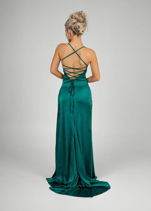 Women's emerald green satin gown with spaghetti straps, thigh slit and ruched detailing for a flattering, figure hugging fit. 