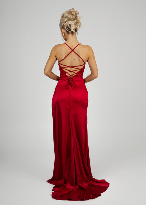 Women's red satin gown with thigh high slit, figure hugging fit and spaghetti straps.