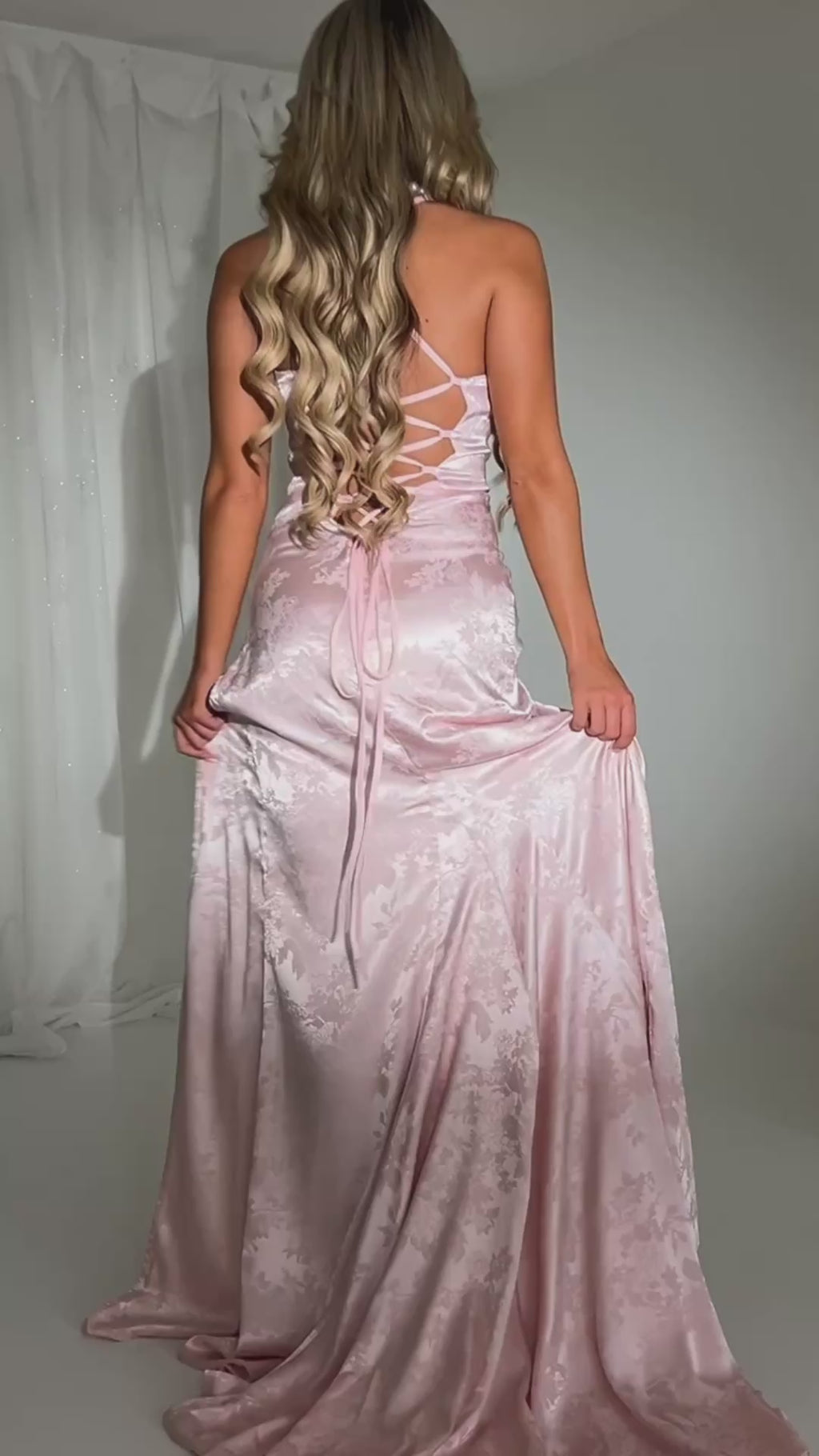 Women's Jacquard pink satin maxi dress with a side split and lace up black detail.