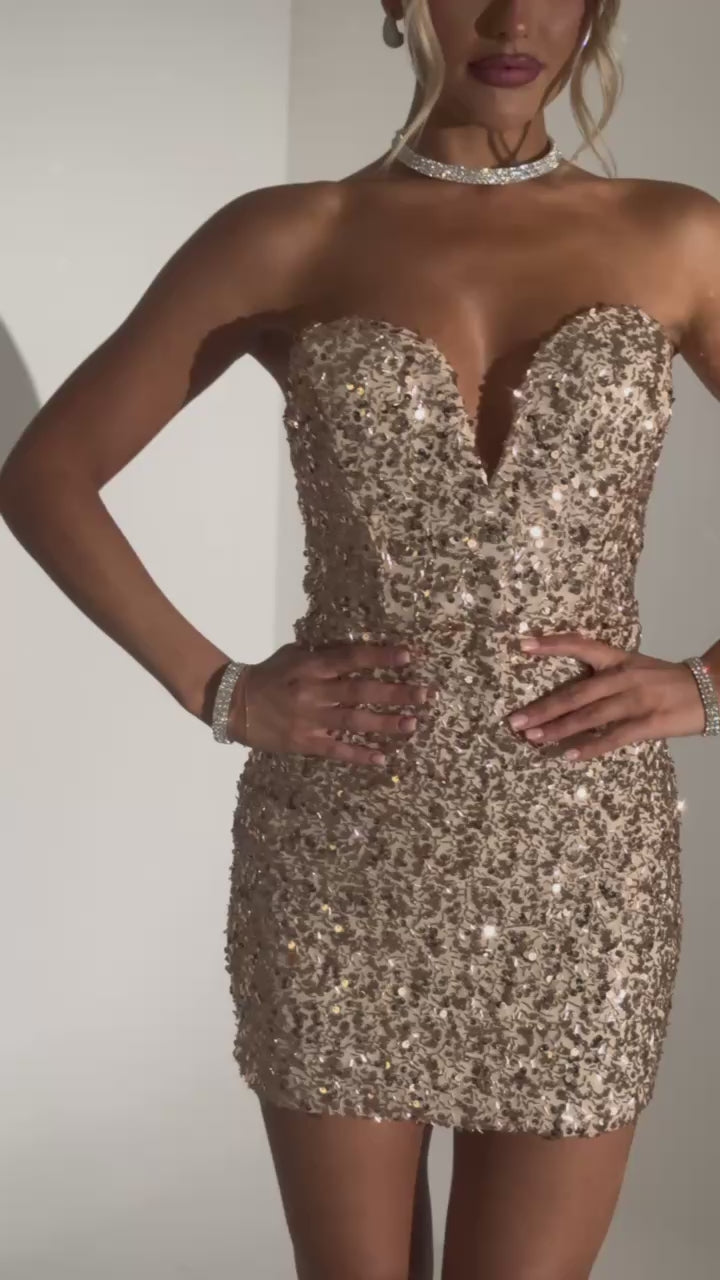 Women’s strapless gold sequin mini dress with V neckline. Bodycon style with a satin bow tie at the back of dress 
