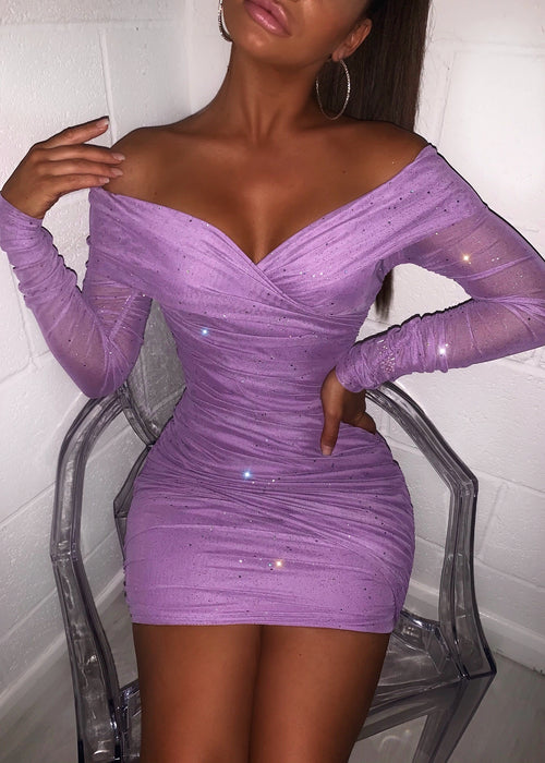 lilac sparkly mini dress with off the shoulder detailing, made from a glitter mesh fabric. Model wears a size XS as shown in the headshot. 